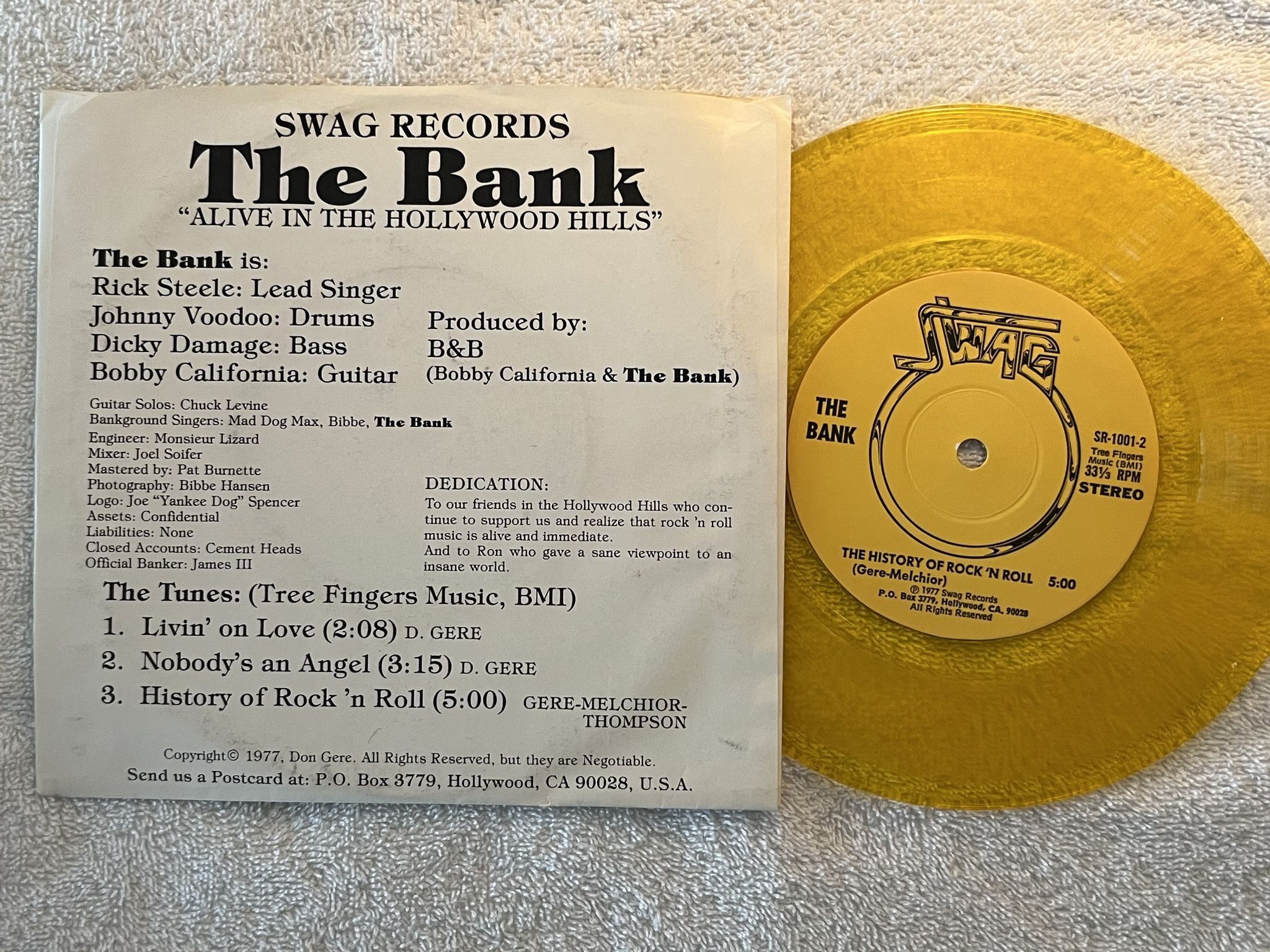 Omslagsbild för skivan THE BANK Alive In Hollywood Hills 7" -77 US SWAG SR-1001 ** INDIE ROCK **