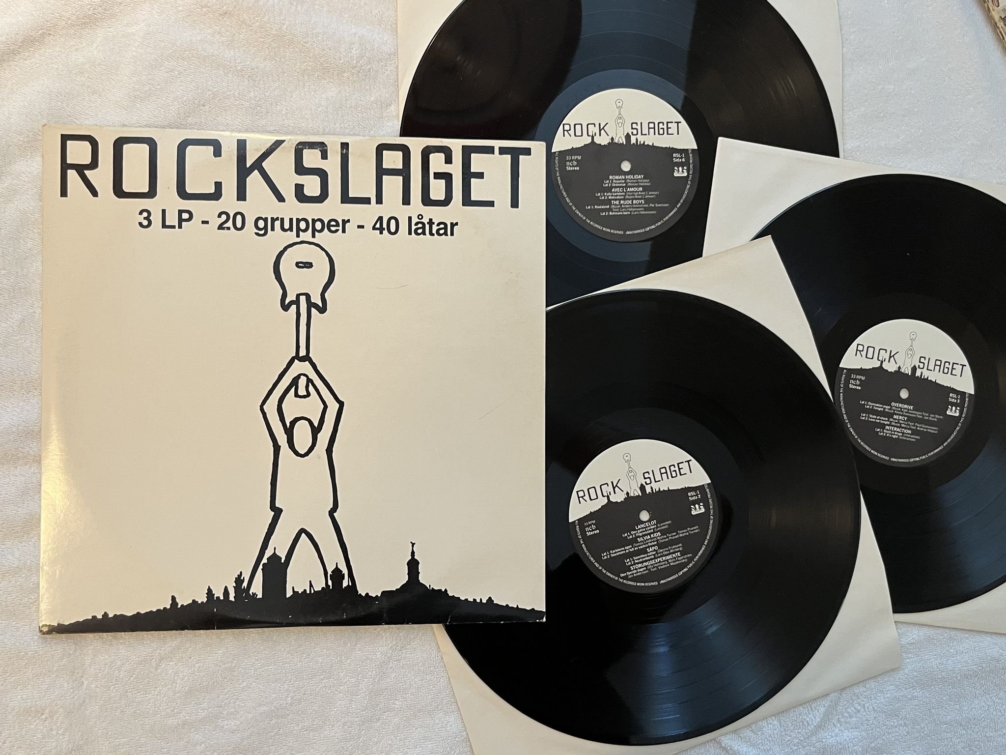 Omslagsbild för skivan V/A Rockslaget - 20 Grupper 40 Låtar 3xLP -81 RSL-1 ** UNDERBAR SAMLING **