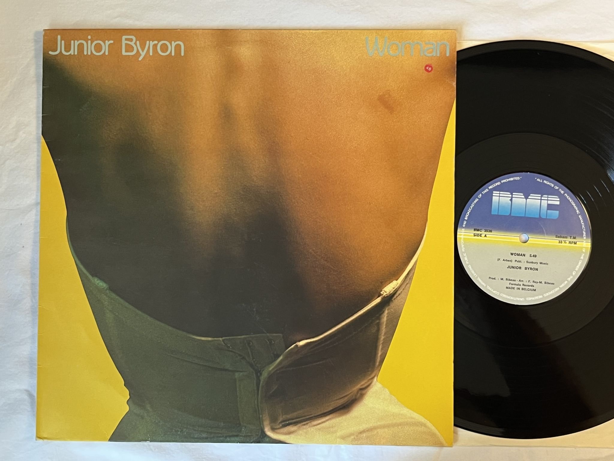 Omslagsbild för skivan JUNIOR BYRON Woman / Dance To The Music 12" -83 Belgium BMC 3536