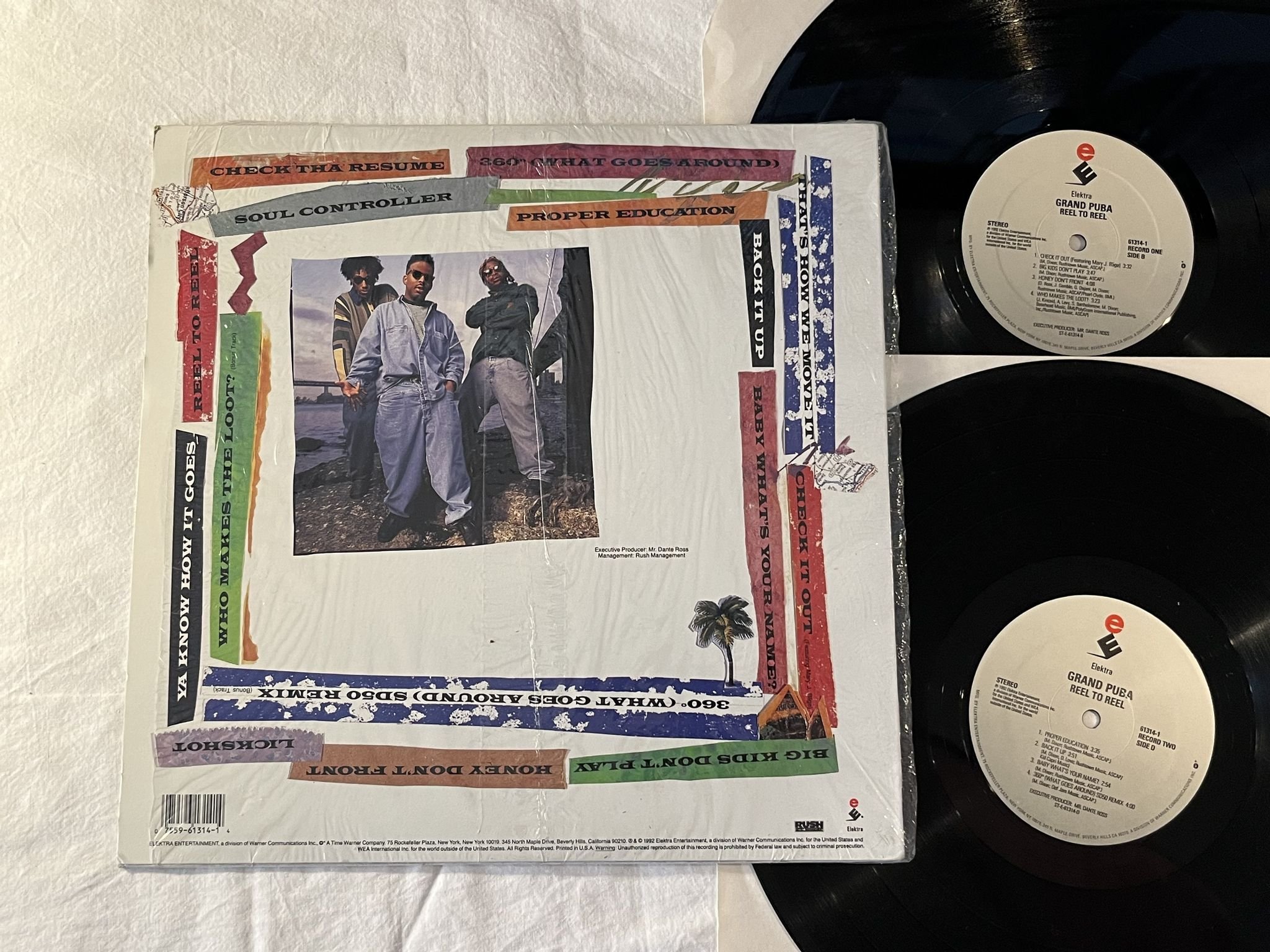 Omslagsbild för skivan GRAND PUBA Reel To Reel 2xLP -92 US ELEKTRA 61314-1 ** HYPE STICKER **