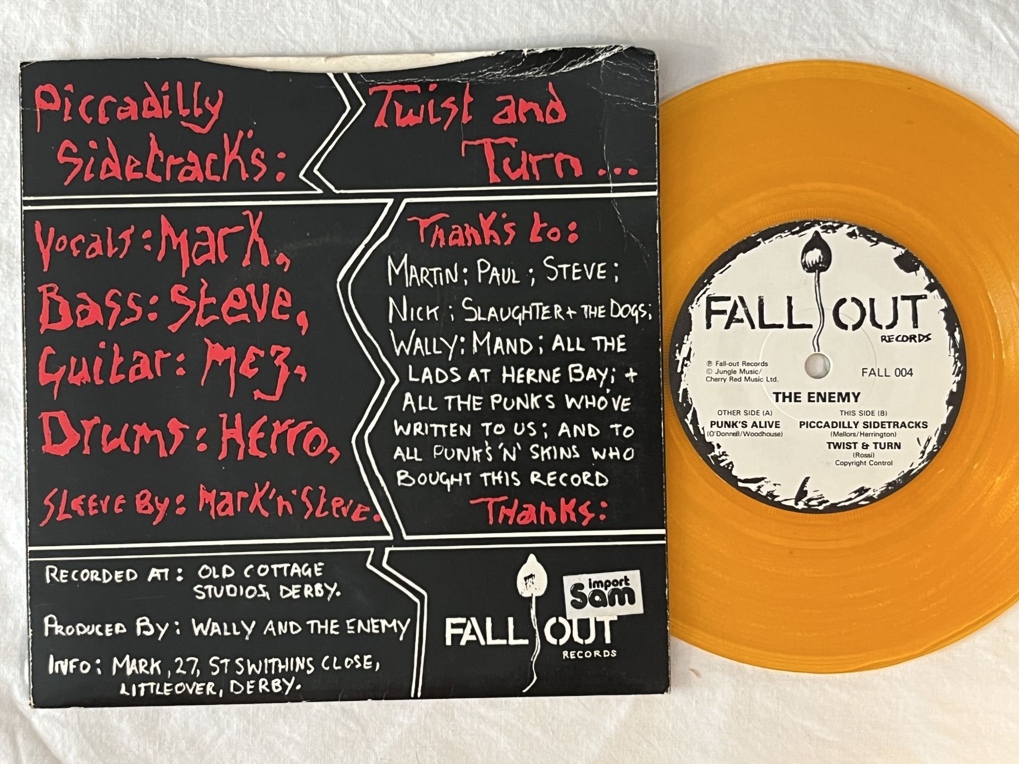Omslagsbild för skivan THE ENEMY punk's alive 7" -82 UK FALLOUT RECORDS FALL 004 ** orange vinyl **